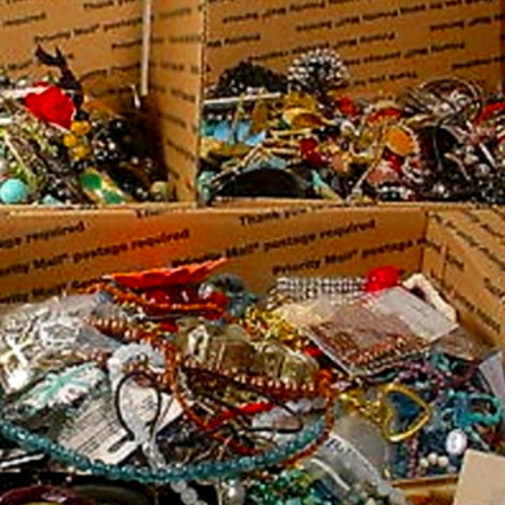 Bulk box of beaded necklaces and jewelry.